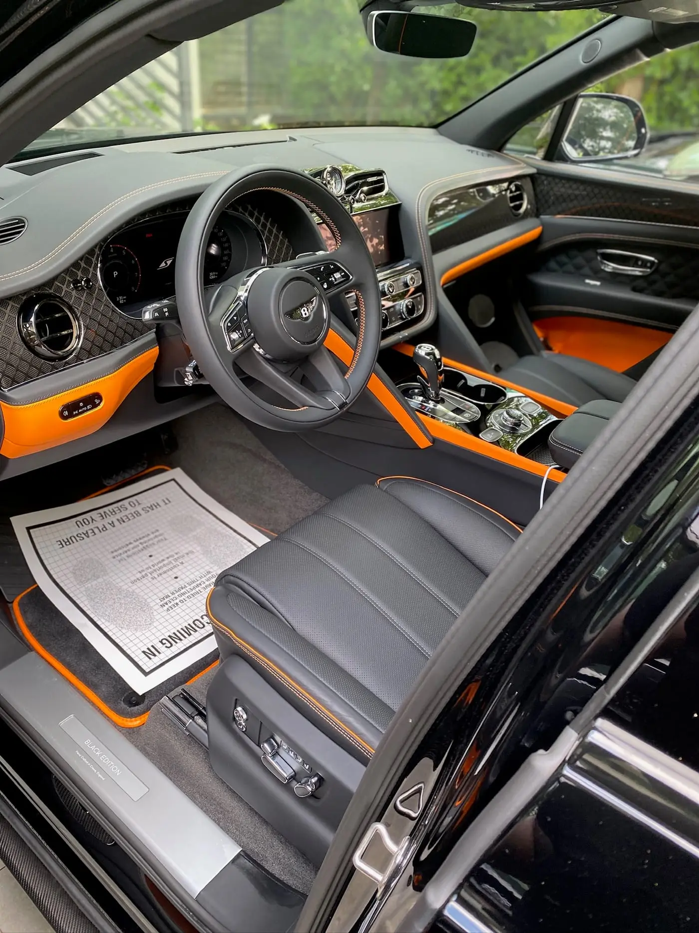 The orange and grey interior of a Bentley Bentayga after an Elite VIP detail