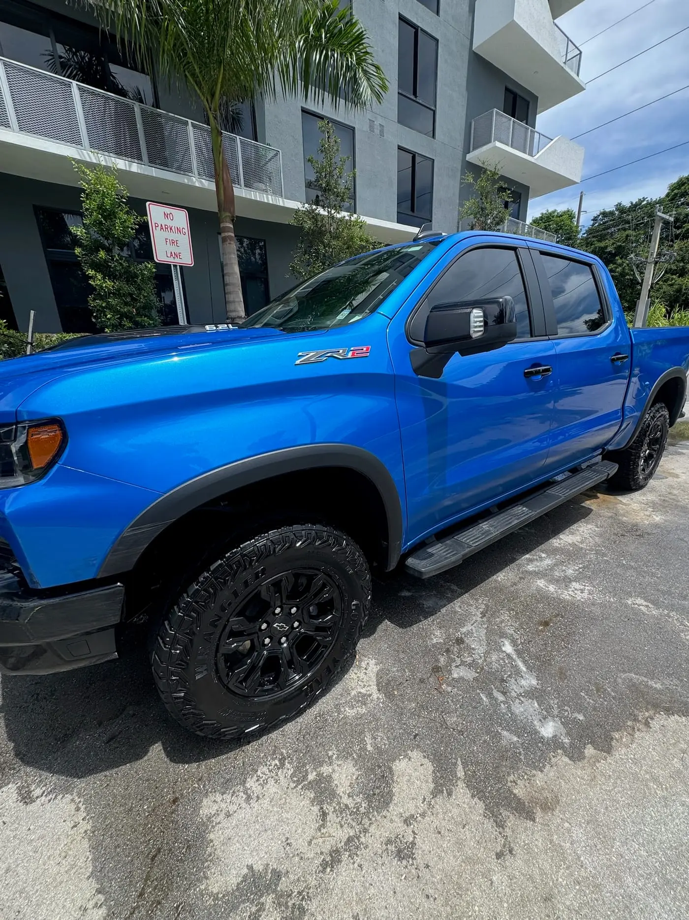 A blue Chevrolet Silverado ZR2 detailed under a Miami palm
