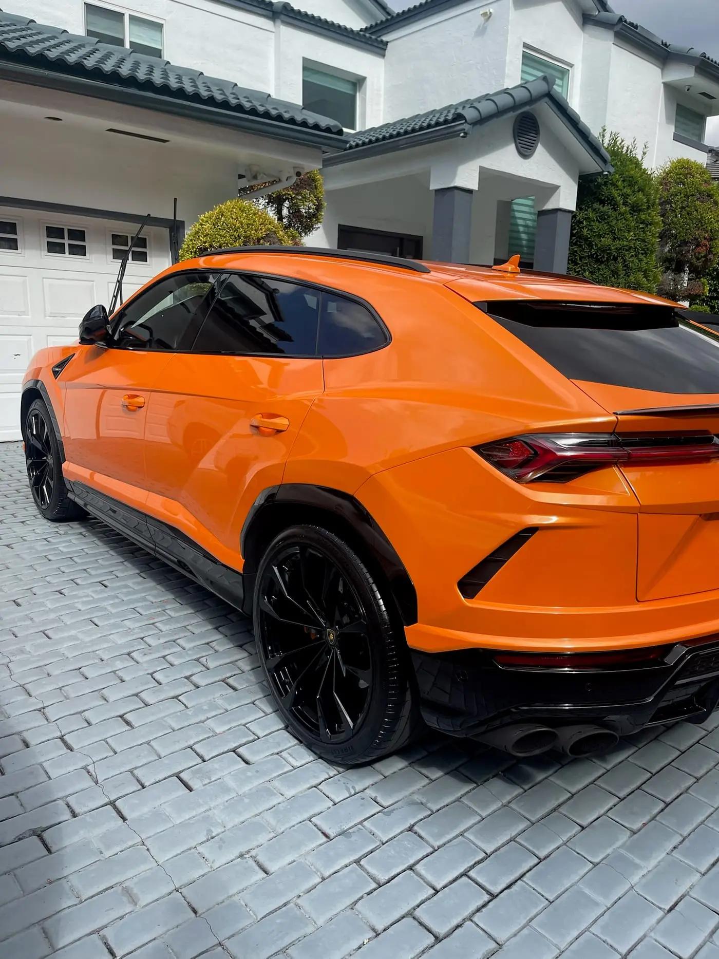 An orange Lamborghini Urus finished to a deep gloss